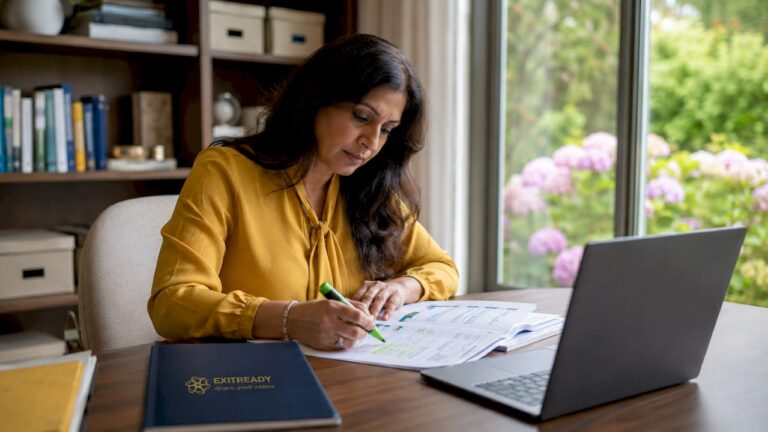 Businesswoman reviewing financial documents at desk