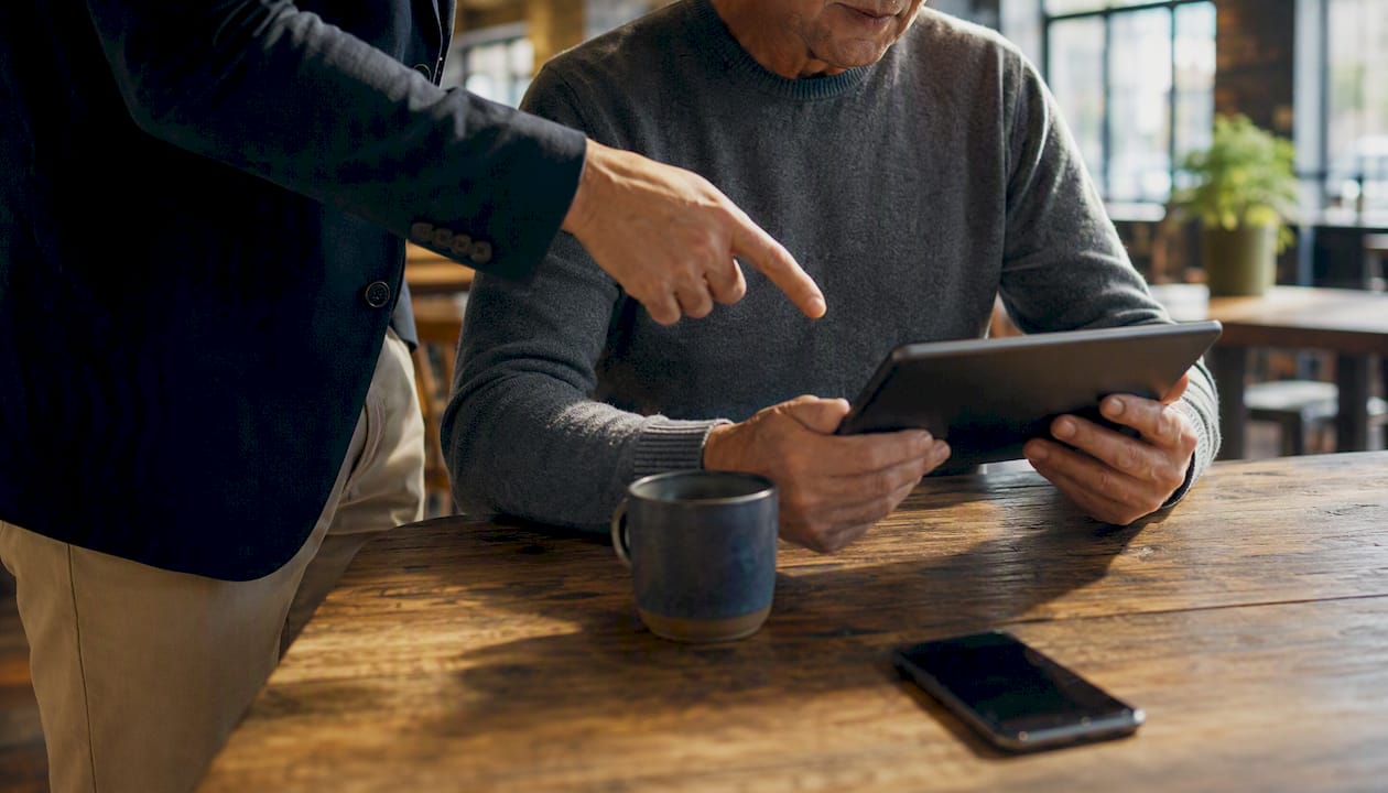 Hands passing tablet with checklist between colleagues