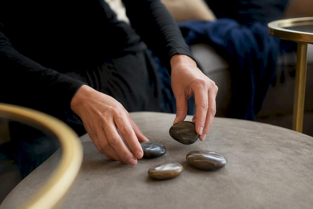 Hands moving labeled blocks on desk