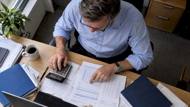 Owner reconciling earnings records and cash flow